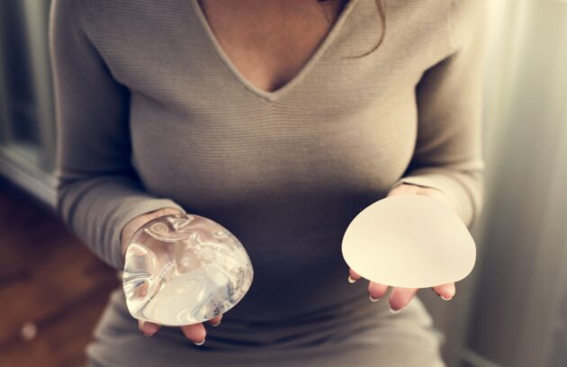 Woman holding silicon bags for breast implant